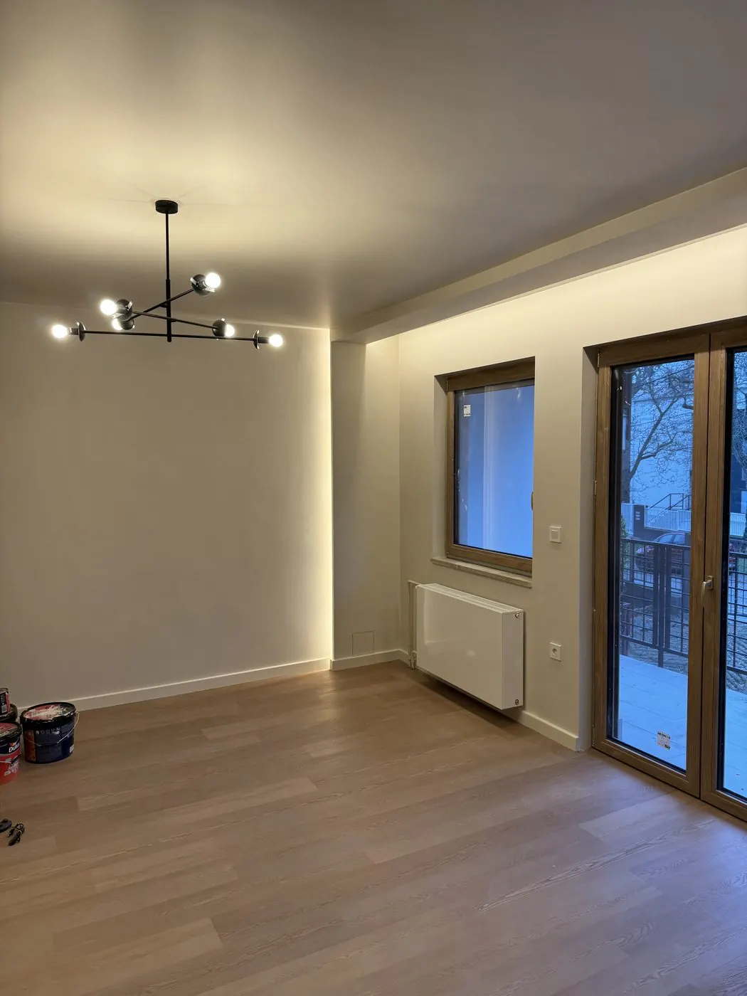 Renovated room of a second-hand flat with fresh paint and a new terrace door