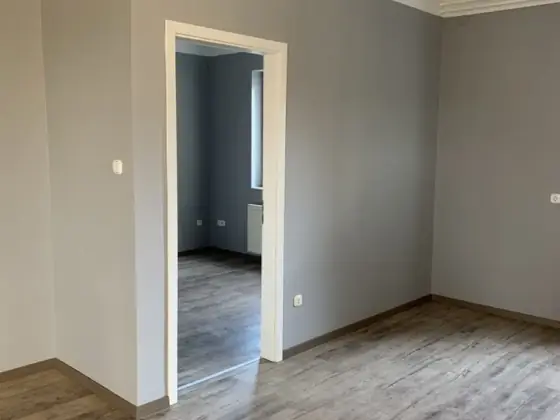 Szürkére festett szoba új padlóval – TeleHome felújítás referencia
