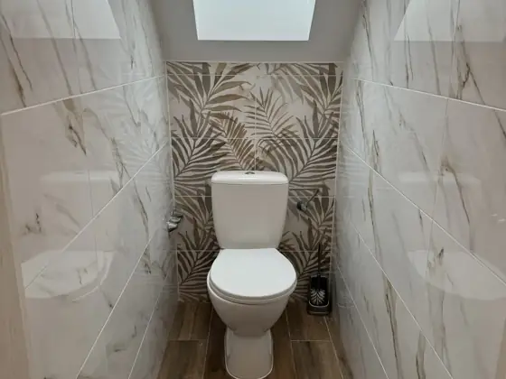 Tetőtéri WC mintás tapétával – TeleHome felújítás referencia